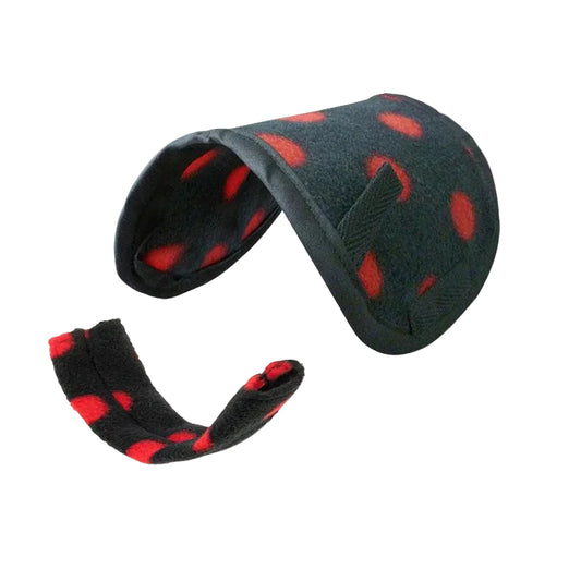A set of black saddle pad and girth cover with red dot patterns, including straps and a booklet.